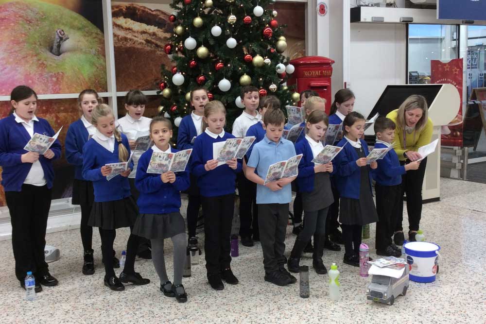 Choir singing for their supper this Christmas at Tesco