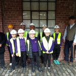 Students wearing helmets ready to go down the mine at Beamish Museum